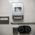 Alameda Post - Menstrual product dispenser on the wall of a public bathroom stall