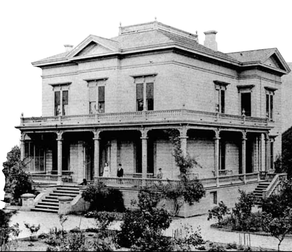 Alameda Post - a black and white photo of a large beautiful old home with a wraparound porch