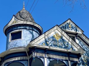 Alameda Post - a beautiful blue Queen Anne style home with a turret and lots of decorative features.