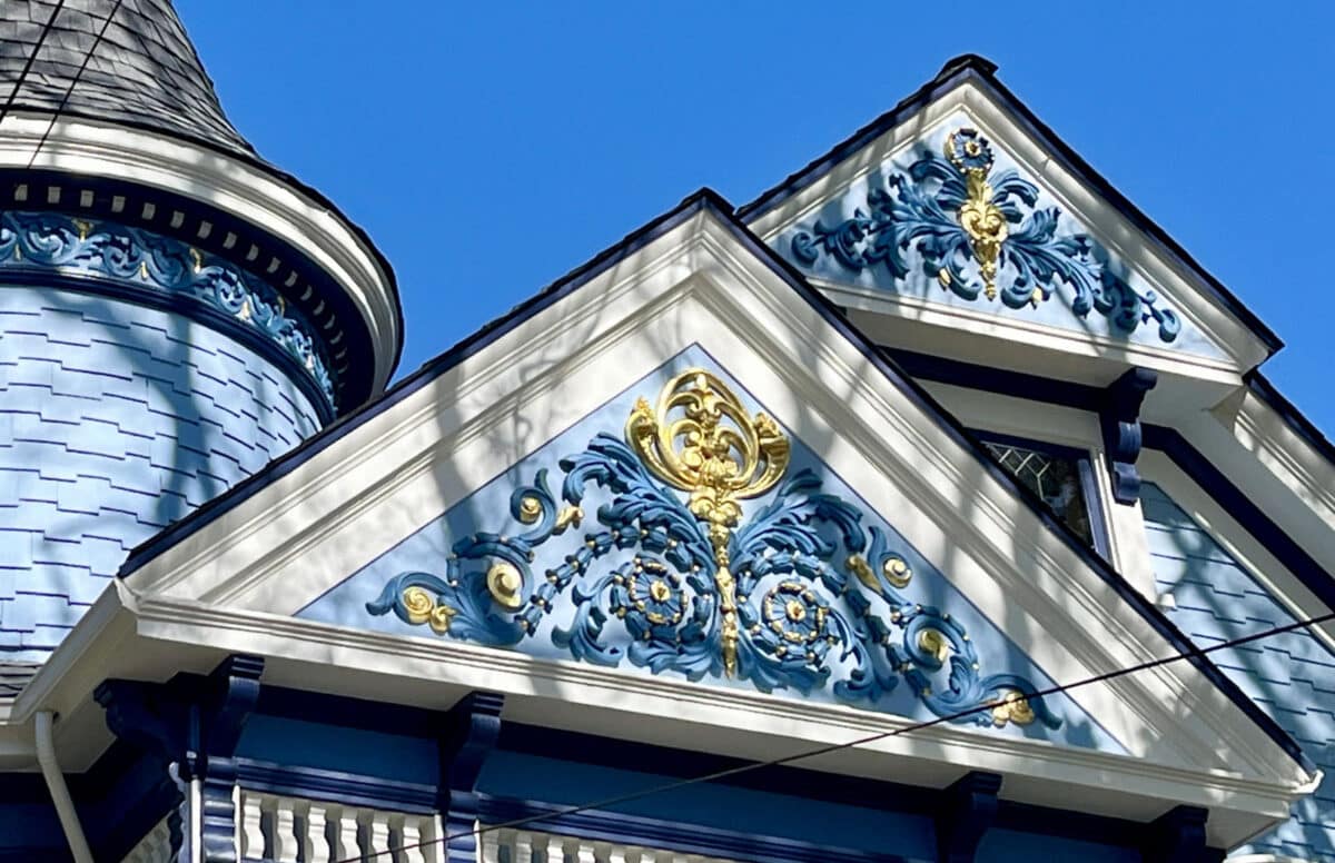 Alameda Post - a beautiful gable, panted blue, white, and gold, on top of 1528 Mozart