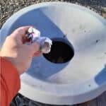 Alameda Post - a person throws trash away