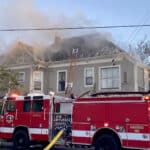 Alameda Post - smoke billows around a home while a firetruck is parked in the street