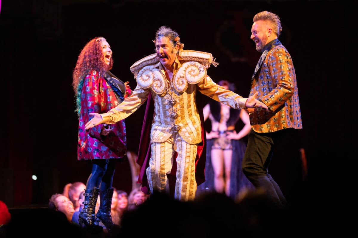 Alameda Post - three performers in costume on stage