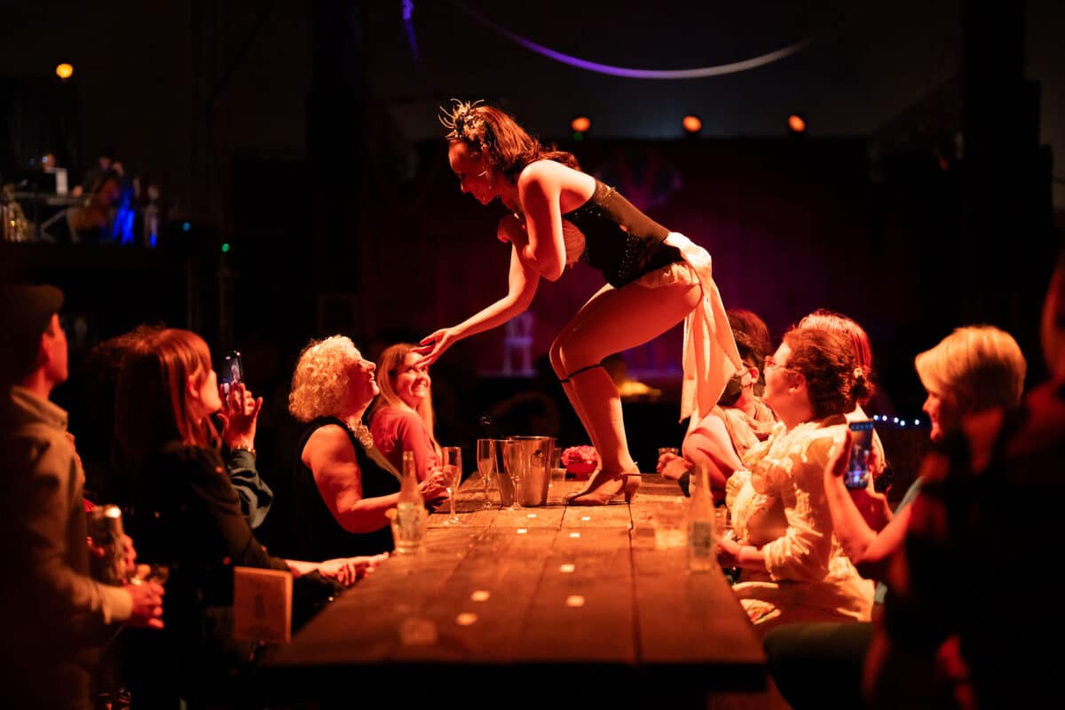 Alameda Post - a performer on a runway interacts with a patrol at the circus