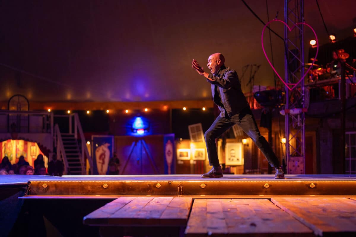 Alameda Post - A man makes a dramatic movement onstage, lunging forward. 