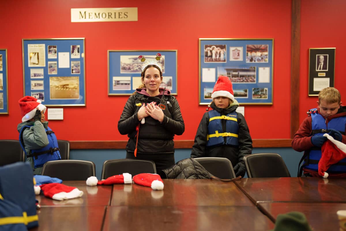 Alameda Post - Inside the Alameda Community Sailing Center, an instructor gears up with young sailors.
