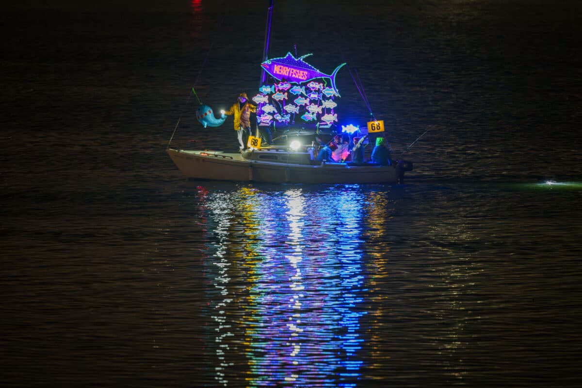 Alameda Post - A boat that says "Merry Fishes" with lots of fish decorations. in the parade.