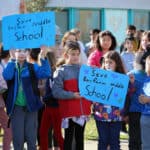 Alameda Post - children gather holding signs that say "Save Bay Farm Middle School"