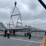 Alameda Post - people walk around a plane on the USS Hornet