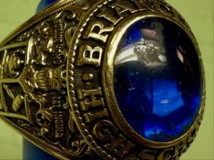 Alameda Post - A gold class ring with a blue stone.