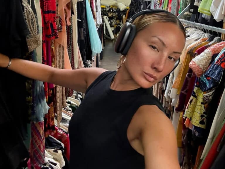 Alameda post - Miyako Bellizi takes a selfie while looking through clothing racks.