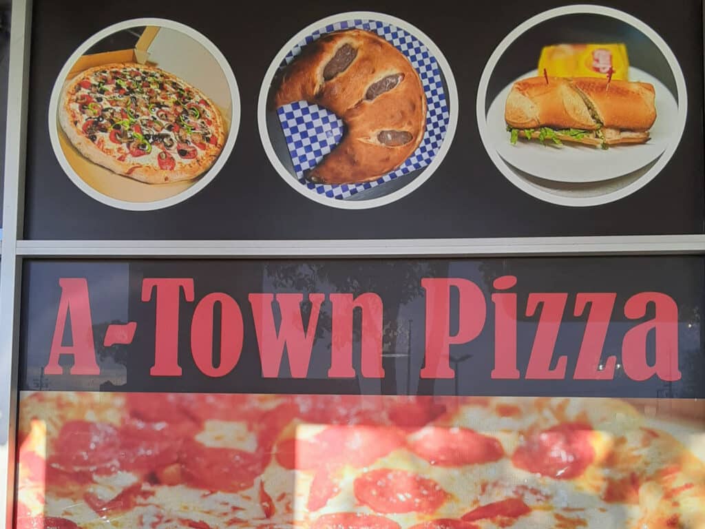 Alameda Post - the sign in the window of A-Town Pizza
