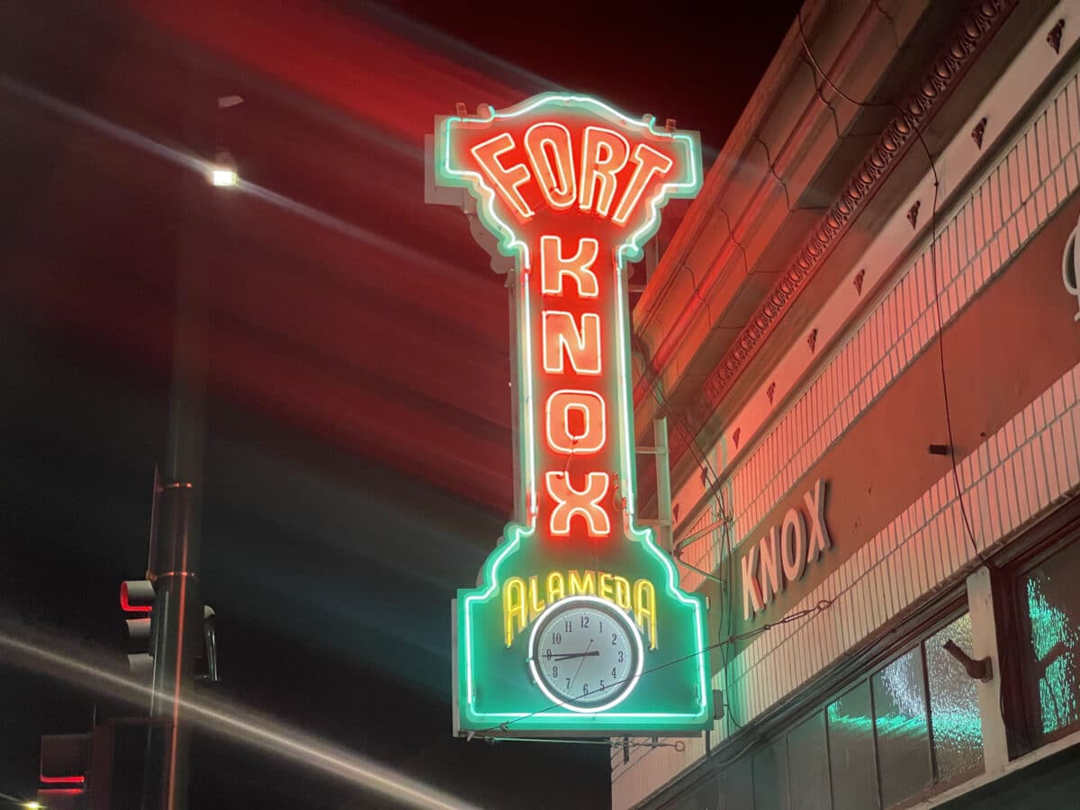 Alameda Post - A neon sign that says Fort Knox Alameda and contains a clock. 