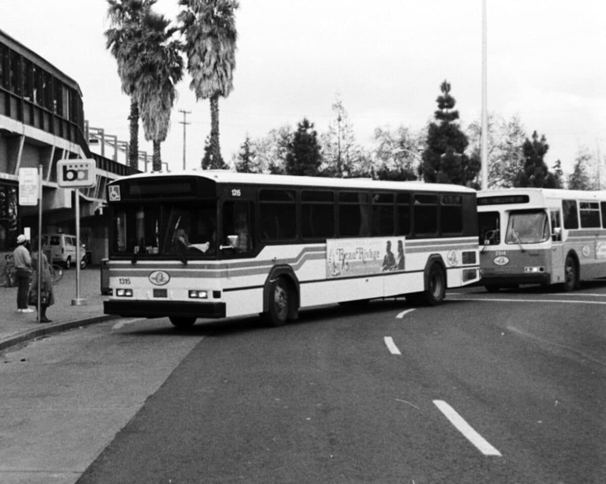 Alameda Post - a black and white photo of AC Transit buses at a BART station