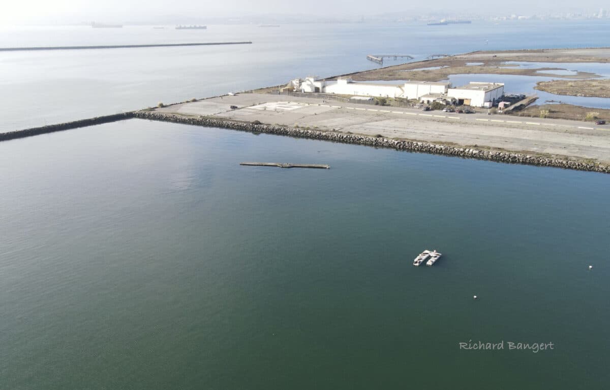 Alameda Post - An aerial photo of Seaplane Lagoon with a small white dot of the floating dock.