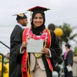 Alameda Post - a student holds their diploma