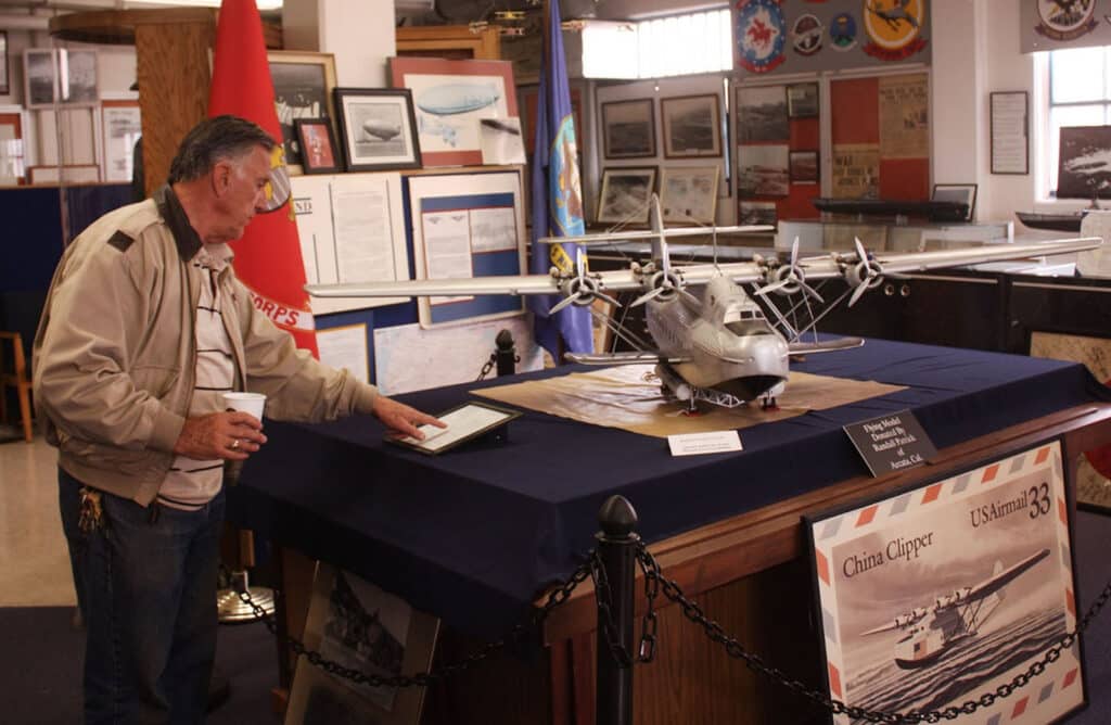 Alameda Post - a man reading an exhibit at the Naval Air Museum about the China Clipper
