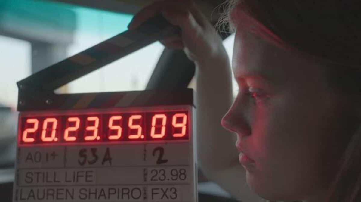 Alameda Post - A young woman stands next to a clapperboard.