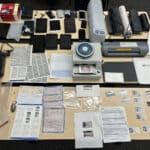 Alameda Post - a table full of phones, scanners, government IDs and documentation, and other items found during the search of an individual's home who was on probation for felony identity theft
