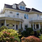 Alameda Post - the back of a grand house at 1240 St. Charles Street. It has multiple porches on the second story