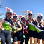 Alameda Post - Boats without Barriers participants wearing rainbow and unicorn hats pose together in their rowing gear
