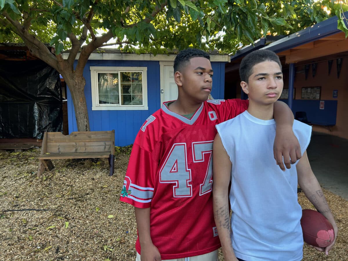 Alameda Post - Two young actors in an outdoor shaded area.