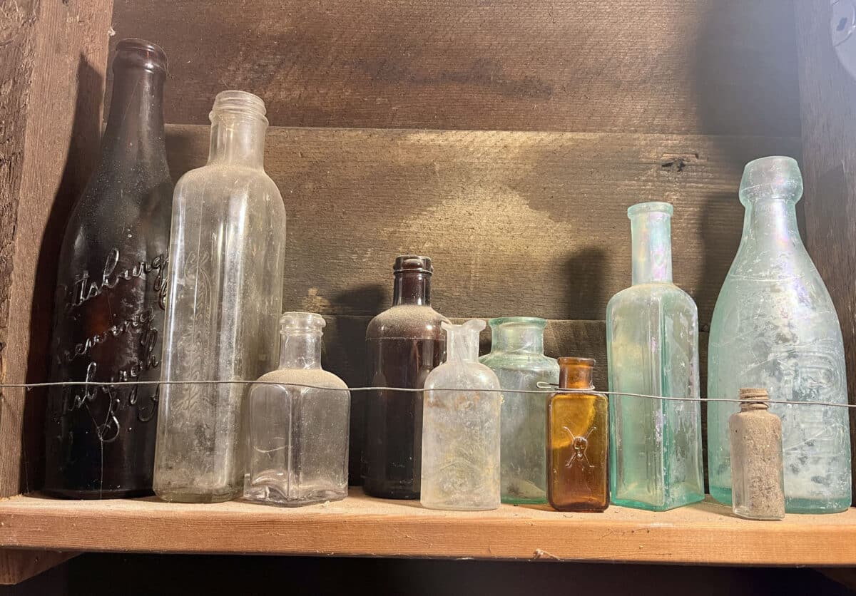 Alameda Post - a shelf full of antique bottles