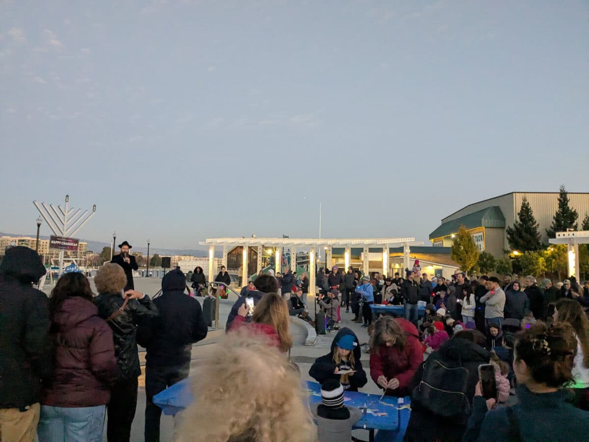 Alameda Post - A crowd gathers at Bohol Circle Immigrant Park for a menorah lighting. 
