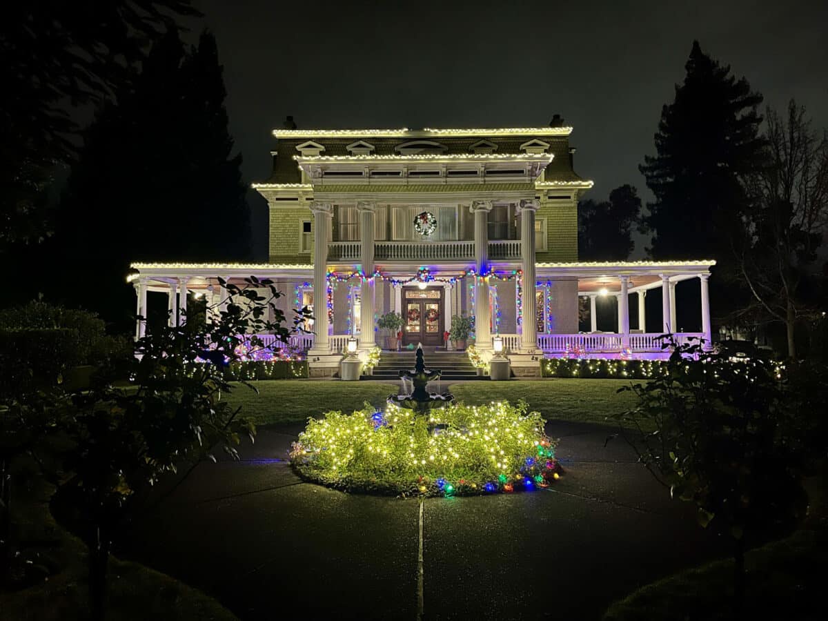 Alameda Post - The Churchill Manor with Christmas lights at night.