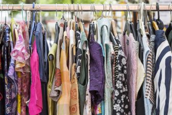 Alameda Post - A rack of second hand clothes.