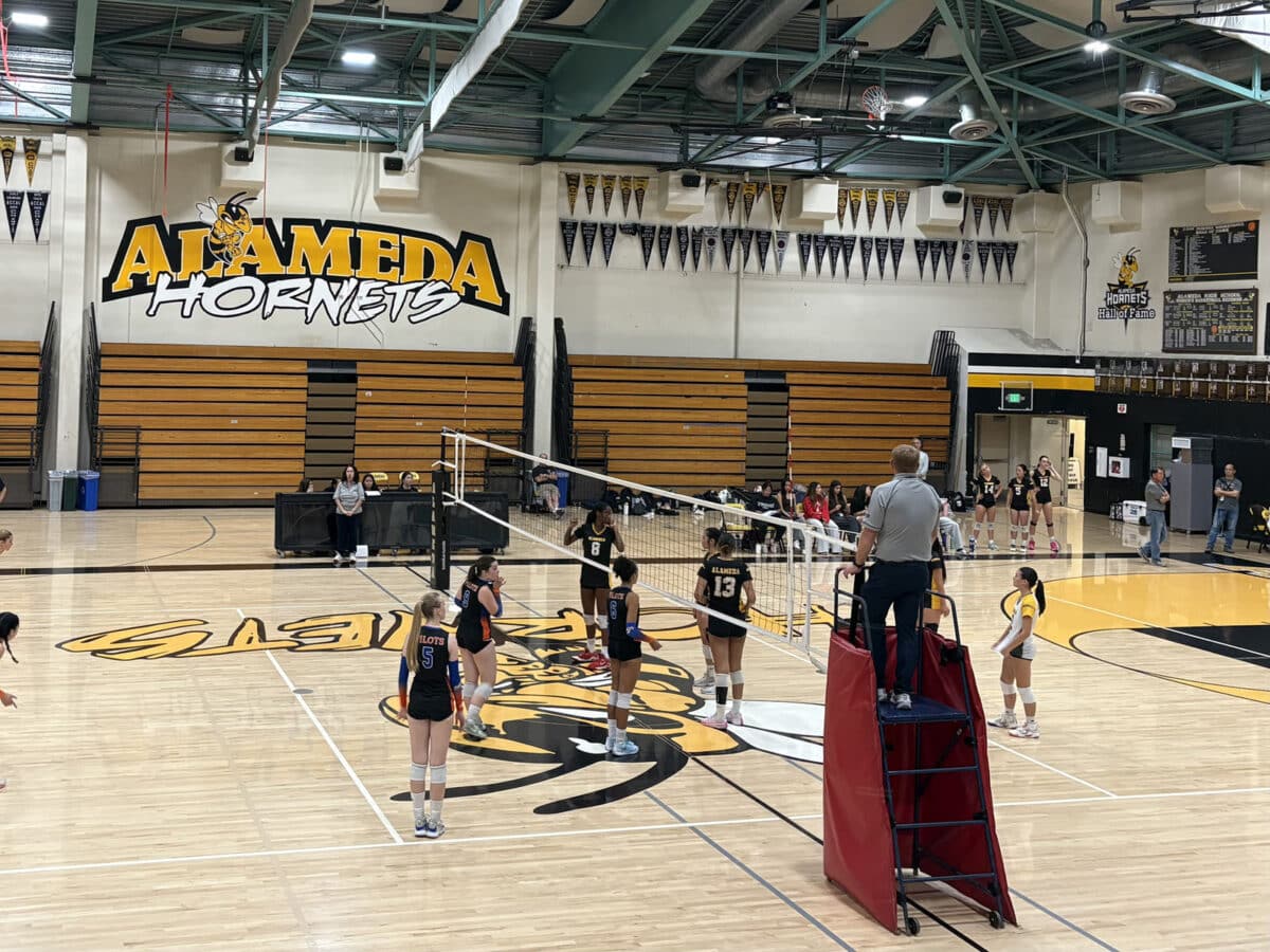 Alameda Post - In the Alameda High School gym, the AHS and SJND volleyball teams play a match.