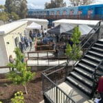 Alameda Post - the courtyard with ramps, a bbq grill, chairs, and tents for the grand opening event