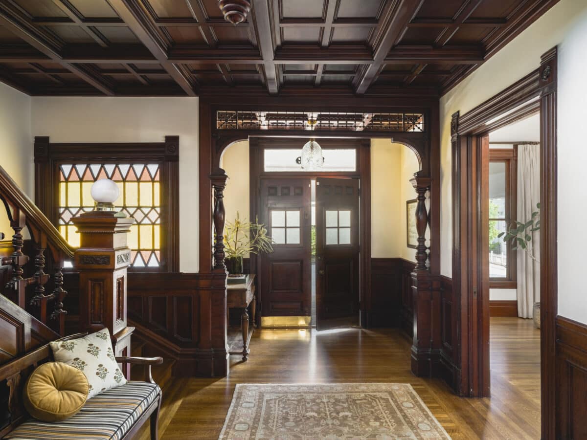 Alameda Post - an entryway with dark, rich wooden details
