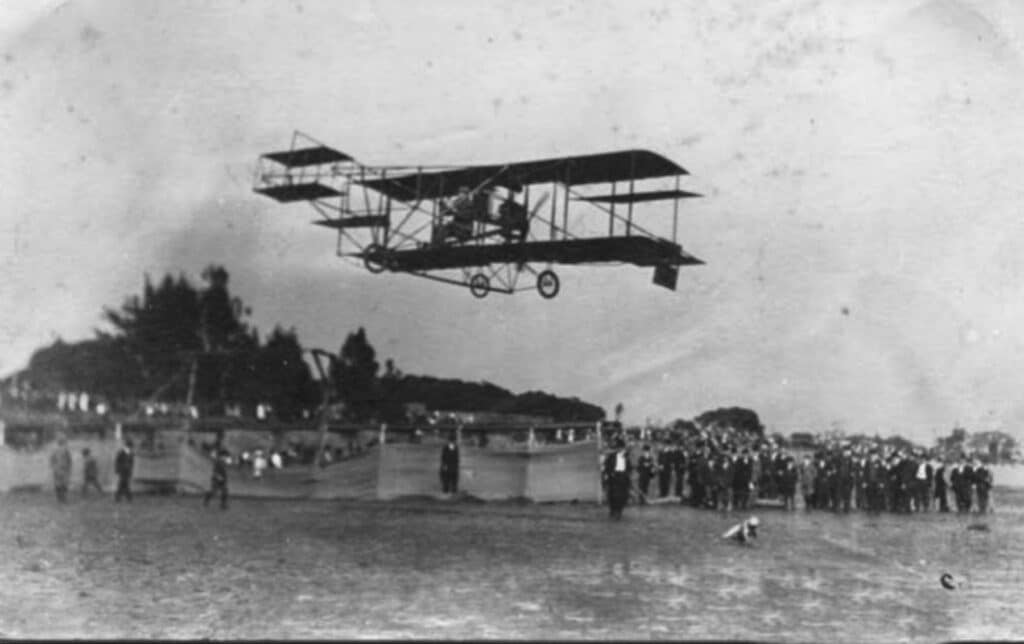 Alameda Post - an early biplane known as a Curtiss Pusher flies over Alameda's Sunset Field.