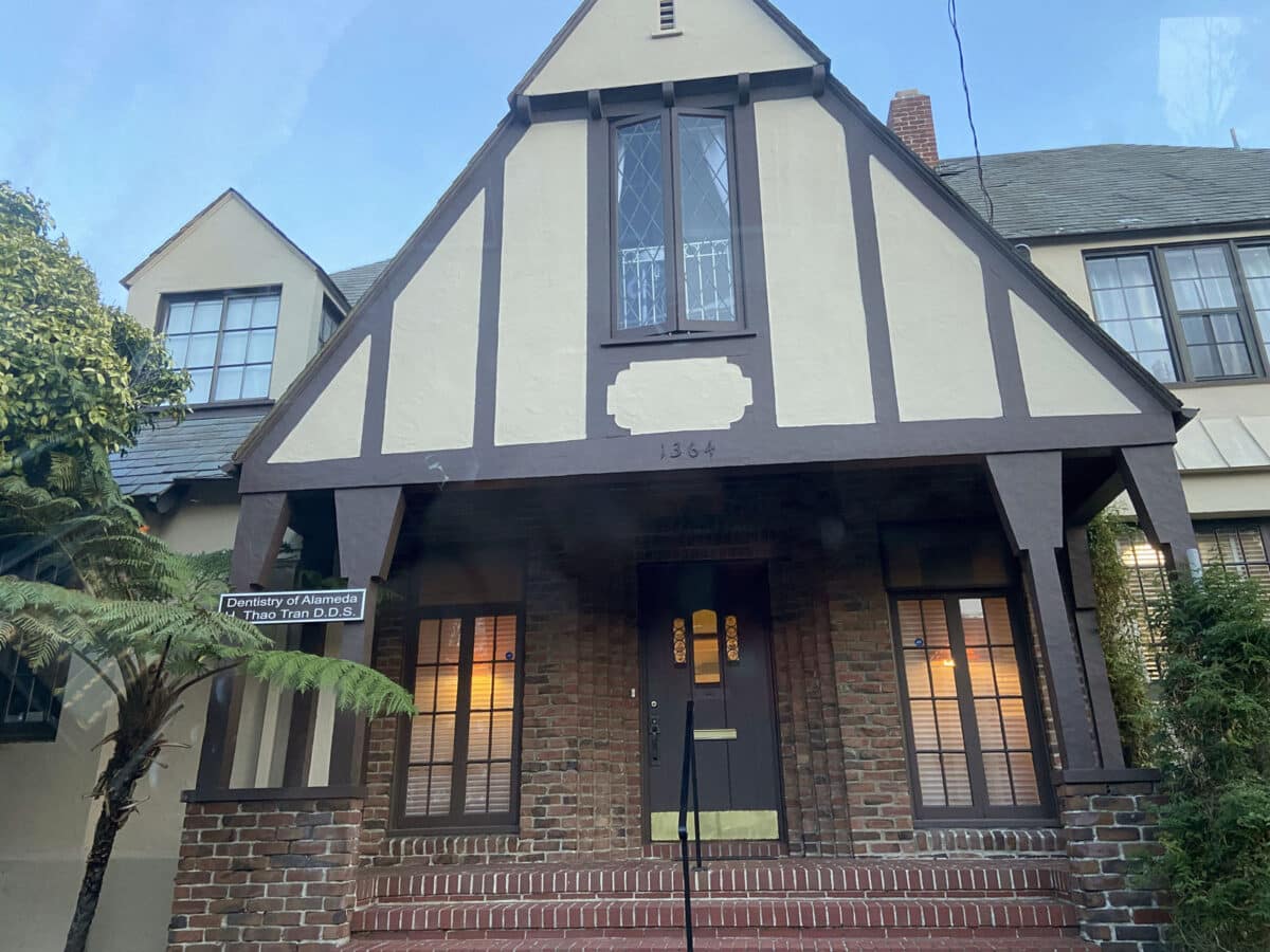 Alameda Post - the front of a residence with a dental office sign out front
