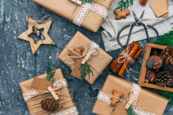 Alameda Post - Packages wrapped in brown paper and string with pinecones, cinnamon sticks, and wooden details.