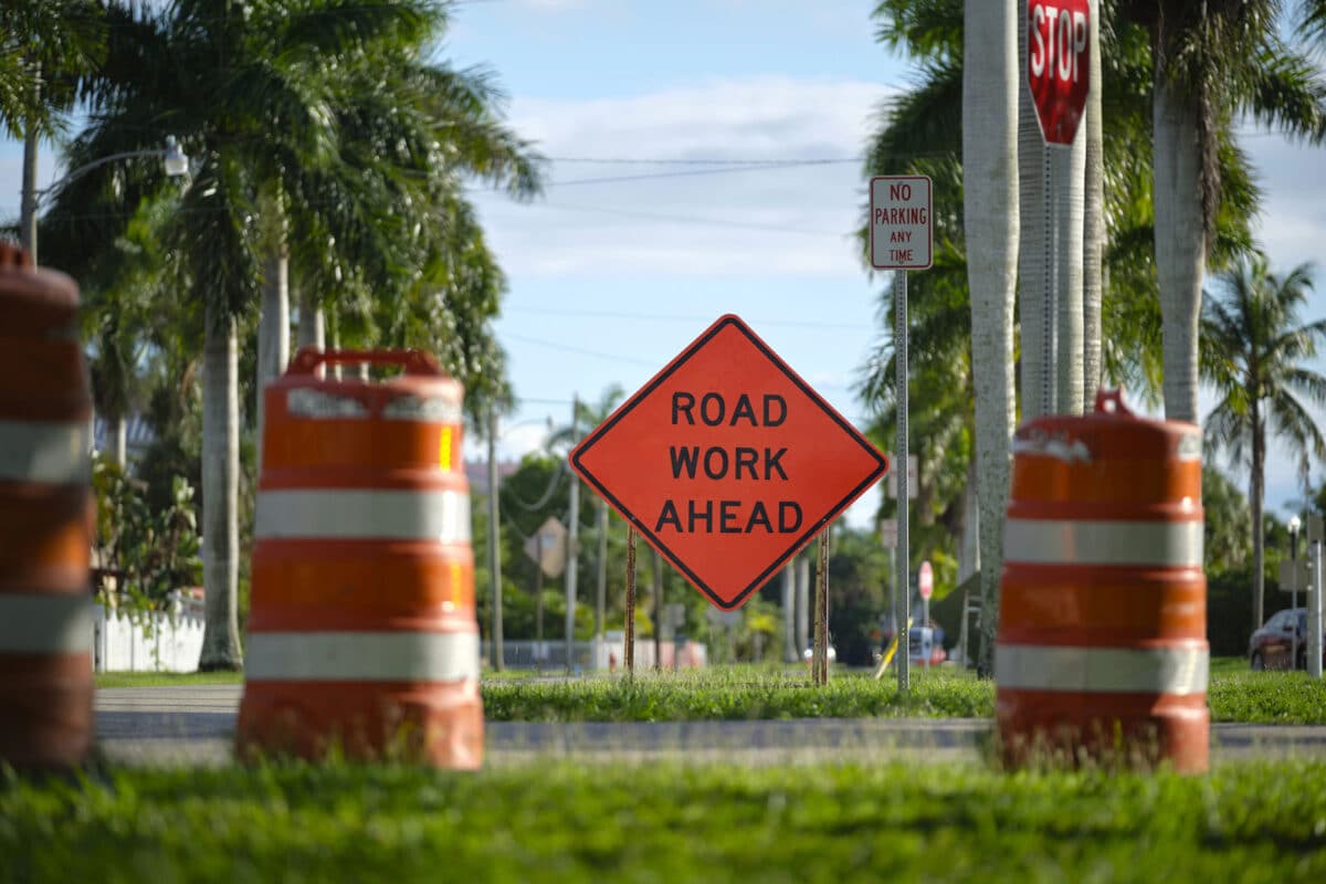 Alameda Post - A photo of traffic markers and a sign that says Road Work Ahead.