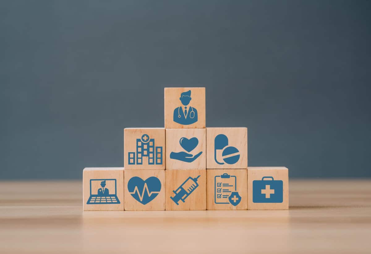 Alameda Post - Building blocks with healthcare symbols like medication and a doctor.