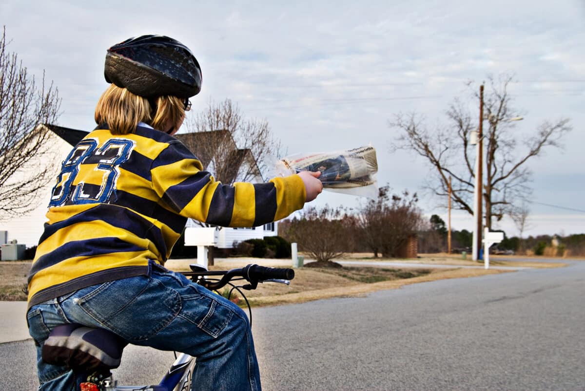 Alameda Post - A boy on a bicycle delivering newspapers.