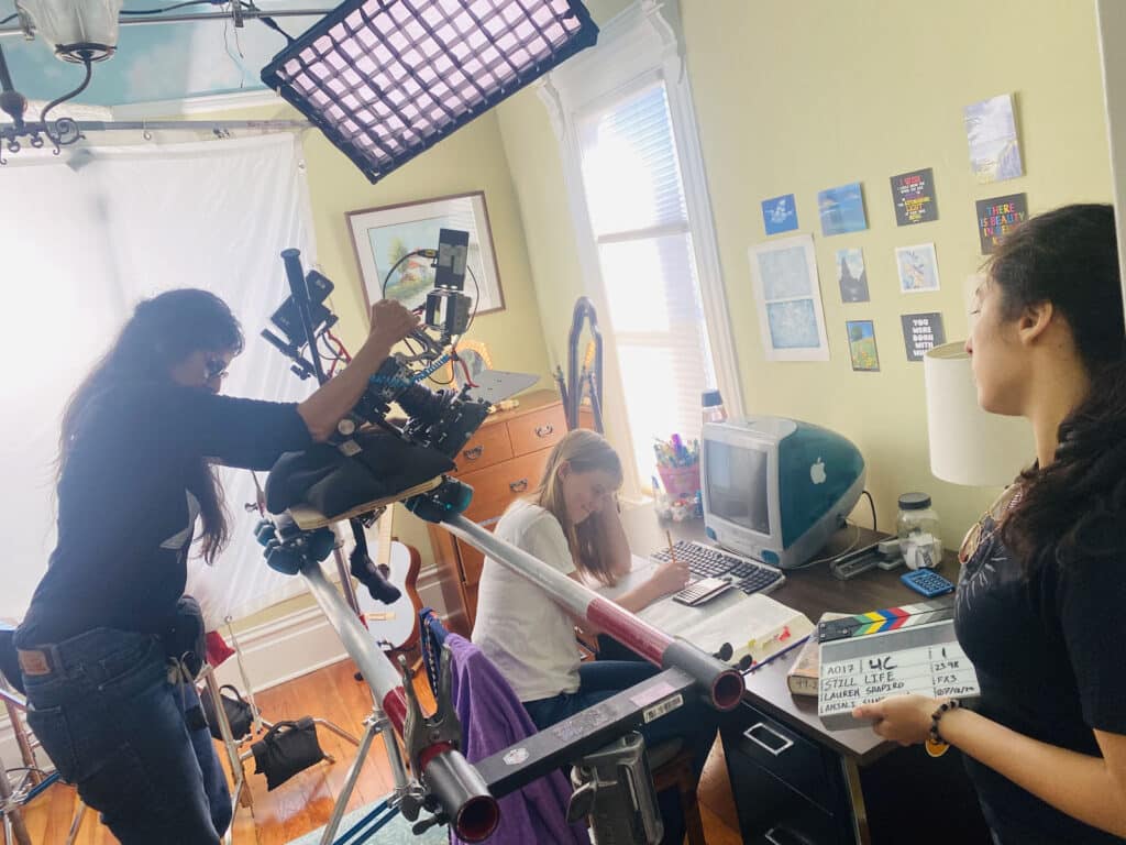 Alameda Post - the film set for Still Life, where a camera operator shoots footage of a girl sitting and doing homework at a desk
