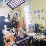 Alameda Post - the film set for Still Life, where a camera operator shoots footage of a girl sitting and doing homework at a desk
