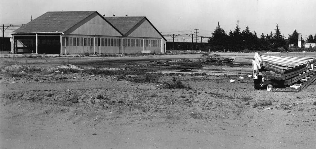 Alameda Post - a black and white photo of old Alameda Airport buildings being deconstructed to develop the Alameda Naval Air Station