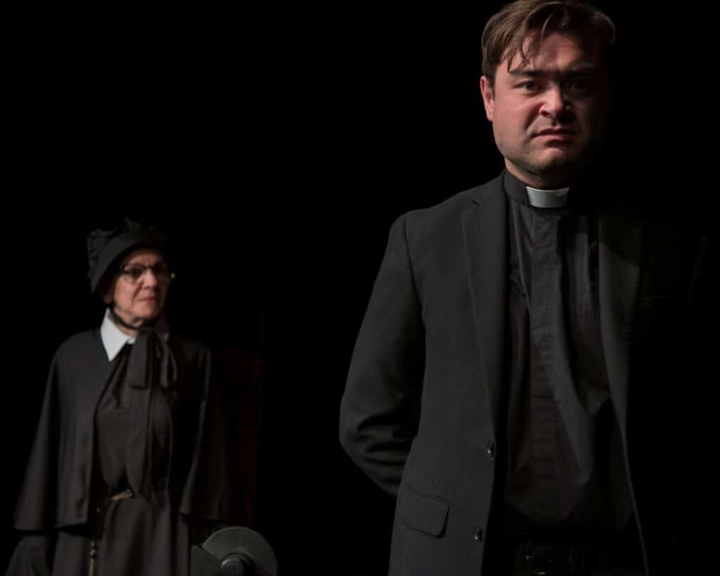 Alameda Post - A priest and a nun looking stern.