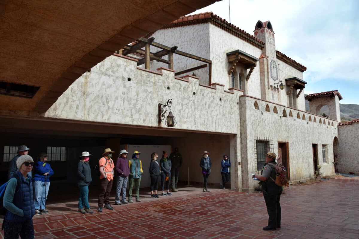 Alameda Post - in the courtyard of Scotty's castle, a park ranger talks to a group of tourists