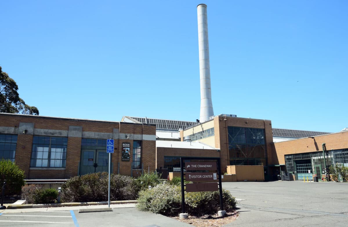 Alameda Post - the outside of a brick building with a large chimney