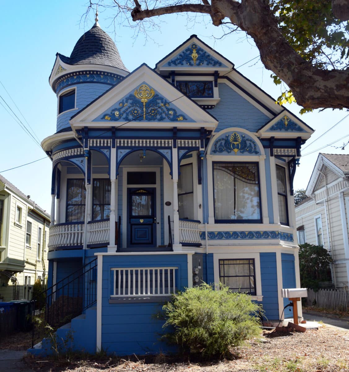 Alameda Post - 1528 Mozart Street standing proudly, underneath the partial shade of a large tree