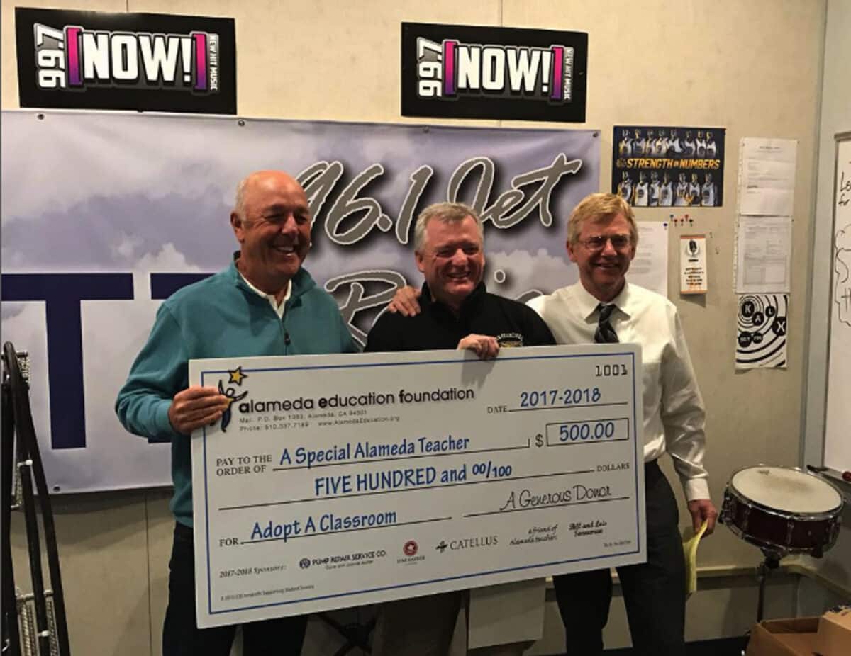 Alameda Post - Kevin Gorham holds a large check for $500 along with two other people