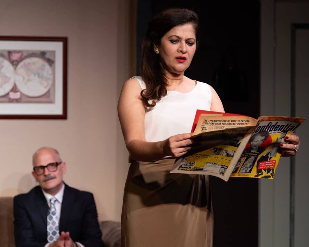 Alameda Post - Actors onstage perform The Wisdom of Eve. A woman reads a magazine while a man looks on.