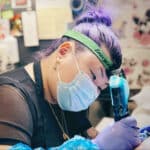 Alameda Post - Mynt Ortega tattooing a client