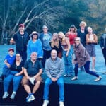 Alameda Post - actors take a ground photo outdoors at an amphitheater